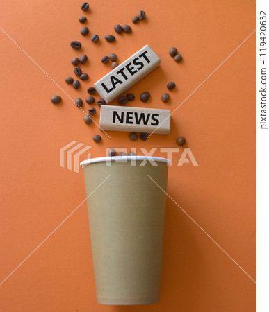 Latest News symbol. Concept word Latest News on wooden blocks. Beautiful orange background with coffee cup. Business and Latest News concept. Copy space 119420632