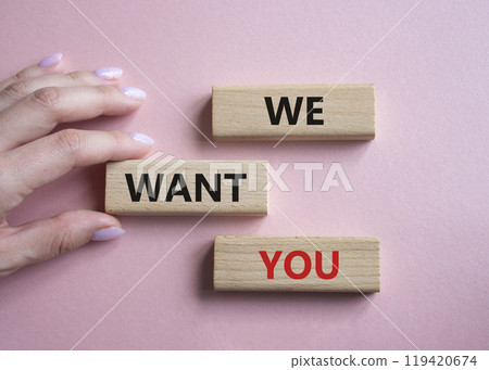 We want you symbol. Concept words We want you on wooden blocks. Businessman hand. Beautiful pink background. Business and We want you concept. Copy space. 119420674