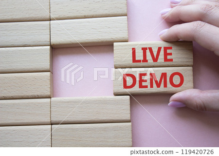 Live Demo symbol. Concept word Live Demo on wooden blocks. Beautiful pink background. Businessman hand. Business and Live Demo concept. Copy space Live Demo symbol. Concept word Live Demo on wooden blocks. Beautiful pink background. Businessman hand. Business and Live Demo concept. Copy space 119420726