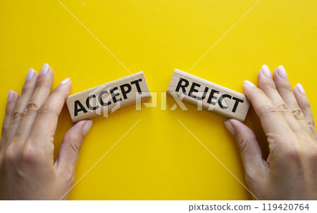Accept or Reject symbol. Concept word Accept or Reject on wooden blocks. Businessman hand. Beautiful yellow background. Business and Accept or Reject concept. Copy space Accept or Reject symbol. Concept word Accept or Reject on wooden blocks. Businessman hand. Beautiful yellow background. Business and Accept or Reject concept. Copy space 119420764