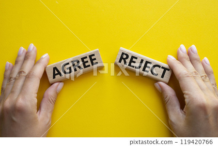 Agree or Reject symbol. Concept word Agree or Reject on wooden blocks. Businessman hand. Beautiful yellow background. Gender and Agree or Reject concept. Copy space 119420766