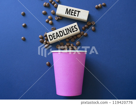 Meet Deadlines symbol. Concept word Meet Deadlines on wooden blocks. Beautiful deep blue background with coffee beans and cup. Business and Meet Deadlines concept. Copy space Meet Deadlines symbol. Concept word Meet Deadlines on wooden blocks. Beautiful deep blue background with coffee beans and cup. Business and Meet Deadlines concept. Copy space 119420776