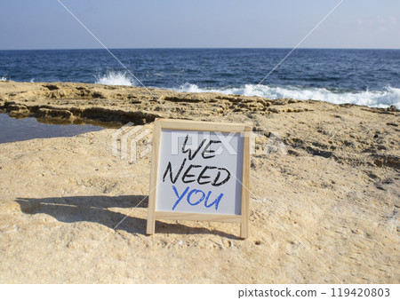We need you symbol. Concept words We need you on white chalk blackboard blocks. Beautiful sea background. Business and We need you concept. Copy space. We need you symbol. Concept words We need you on white chalk blackboard blocks. Beautiful sea background. Business and We need you concept. Copy space. 119420803