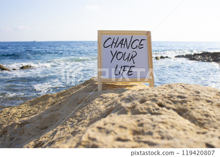 Change your Life symbol. White Blackboard with words Change your Life. Beautiful sea background. Business and Change your Life concept. Copy space. Change your Life symbol. White Blackboard with words Change your Life. Beautiful sea background. Business and Change your Life concept. Copy space. 119420807