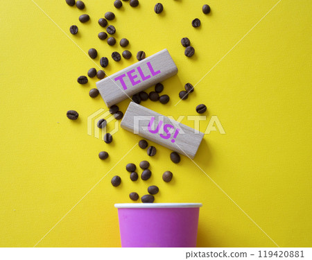 Tell us symbol. Concept words Tell us on wooden blocks. Beautiful yellow background with coffee cup. Business and Tell us concept. Copy space. 119420881