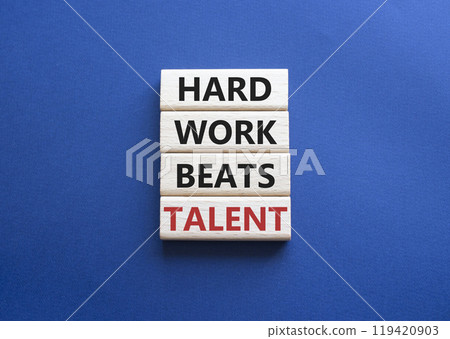 Talent symbol. Concept words Hard work beats talent on wooden blocks. Beautiful deep blue background. Business and Hard work beats talent concept. Copy space 119420903