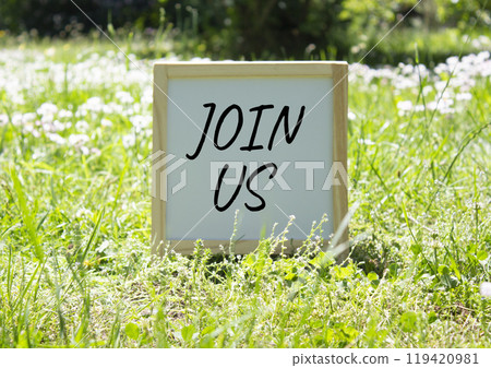 Join us symbol. Concept word Join us on white chalk background. Beautiful meadow background. Business and Join us concept. Copy space 119420981