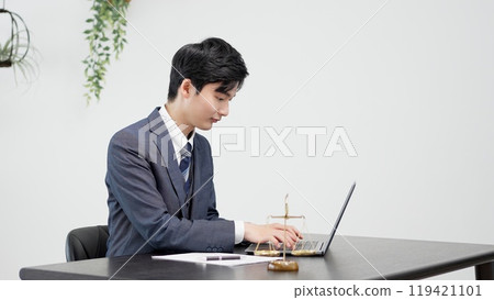 Businessman doing research on a computer Businessman doing research on a computer 119421101