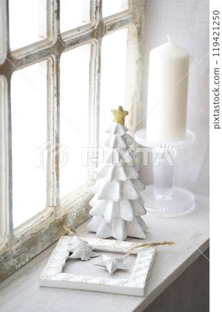 Christmas tree on an antique windowsill 119421250