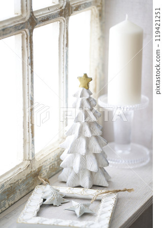 Christmas tree on an antique windowsill 119421251
