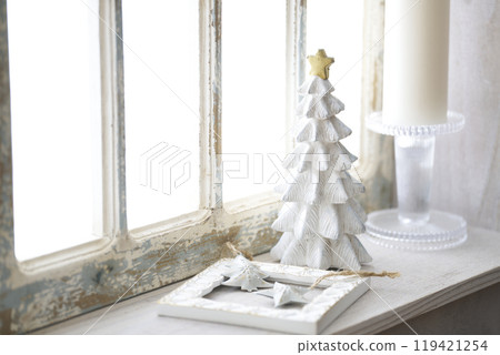 Christmas tree on an antique windowsill 119421254