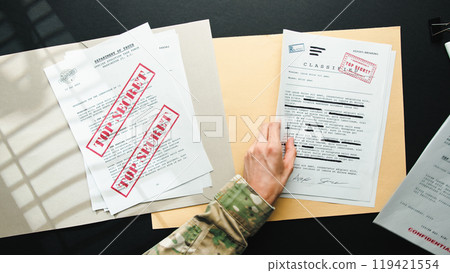 Top Secret papers on desk 119421554