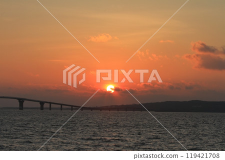 A tropical sunset with crimson clouds seen from the Irabu Bridge A tropical sunset with crimson clouds seen from the Irabu Bridge 119421708