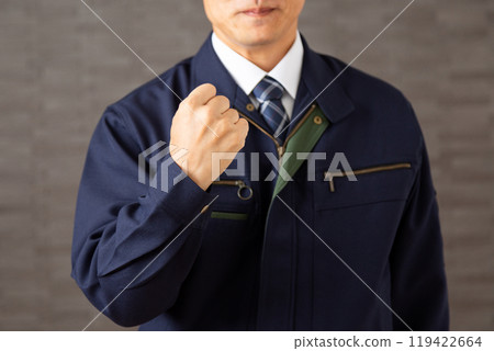 A middle-aged male businessman in work clothes making a fist-pumping gesture A middle-aged male businessman in work clothes making a fist-pumping gesture 119422664