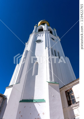 Bell tower of the Vologda Kremlin. A majestic structure with a golden dome against the blue sky. 119422765