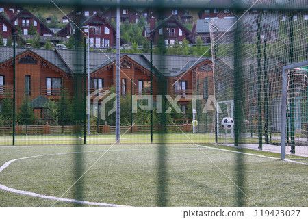 Fenced Football Field With Artificial Grass In A Country Sports Club 119423027