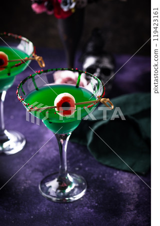 Spooky green halloween cocktail with eyeball 119423161