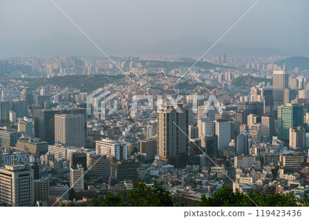 Aerial view of bustling Seoul, South Korea showcasing urban development amid hazy skies during late afternoon 119423436