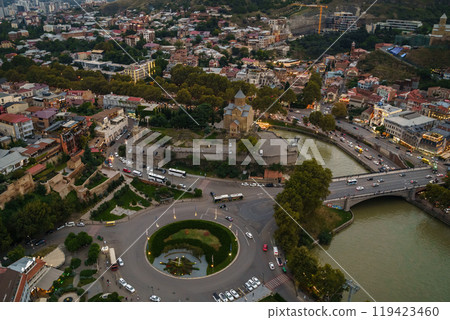 An aerial view of Tbilisis bustling cityscape at twilight encompassing historical architecture An aerial view of Tbilisis bustling cityscape at twilight encompassing historical architecture 119423460