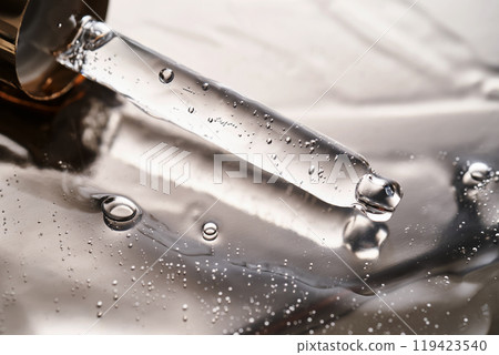 Dropper pipette with delicious serum with bubbles on the gel texture. 119423540