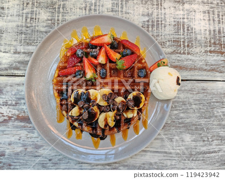 waffles with vanilla ice cream, banana, strawberry and blueberry 119423942