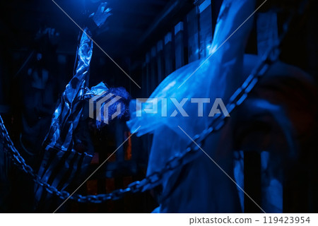 Dead joker model hang and chain by handcuffs in cage. Halloween decor Dead joker model hang and chain by handcuffs in cage. Halloween decor 119423954