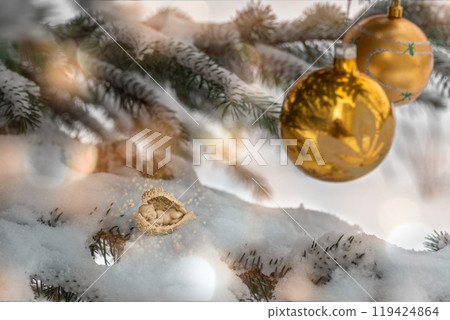 Composition with snow-covered Christmas tree decorated with golden balls and little sleeping angel baby 119424864