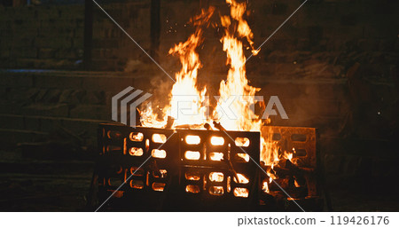 Varanasi, Uttar Pradesh, India. Fire burn faster during a funeral cremation ceremony on Harishchandra Ghat. Harishchandra Ghat is one of the only two ghats serving as cremation sites along Ganges Varanasi, Uttar Pradesh, India. Fire burn faster during a funeral cremation ceremony on Harishchandra Ghat. Harishchandra Ghat is one of the only two ghats serving as cremation sites along Ganges 119426176