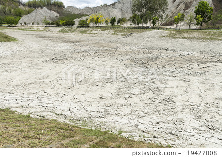 Dry lake bed with the natural texture of cracked clay on the perspective land. Dry lake bed with the natural texture of cracked clay on the perspective land. 119427008