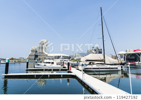 View of Yacht Marina at Glory Pier of Kaohsiung Port, Taiwan. with the Kaohsiung Music Center building. 119427192