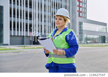 Confident mature female engineer developer inspector at construction site Confident mature female engineer developer inspector at construction site 119427547