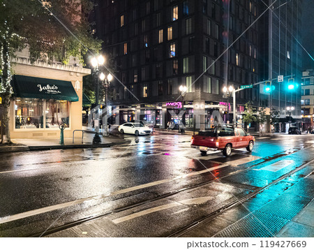 Portland, Oregon, USA - 09.28.2023: Evening on the streets of Portland. Rain and reflections of traffic lights on the pavement. 119427669