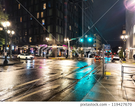 Portland, Oregon, USA - 09.28.2023: Evening on the streets of Portland. Rain and reflections of traffic lights on the pavement. 119427670
