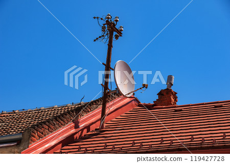 Power lines on the roof of the house. 119427728