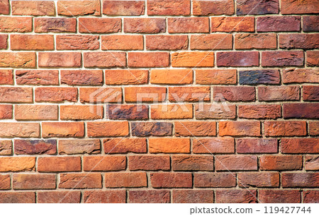 Brick tile wall abstract background. Exterior view of a house made of blocks lined with cement. Exterior wall made of decorative brickwork. 119427744