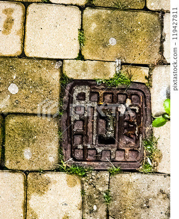 Manhole cover of the gas pipeline system. A massive metal hatch for access to city communications in the pavement. 119427811