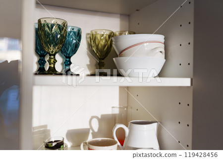 Clean dishes and tableware on white shelf Clean dishes and tableware on white shelf 119428456