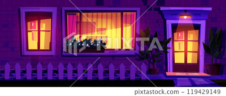 House facade at night with light from windows 119429149