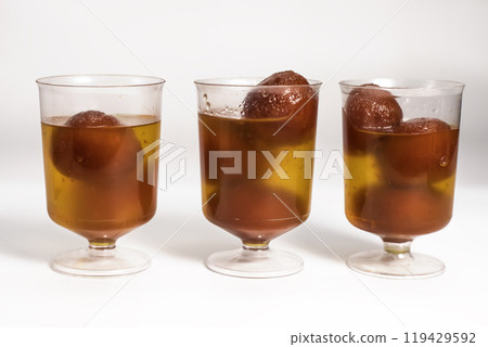 Delicious gulab jamun dessert in glasses with sugar syrup 119429592