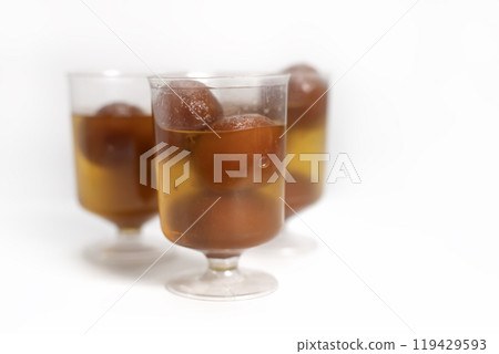 Delicious homemade Indian dessert Gulab Jamun in glass cups on white background 119429593