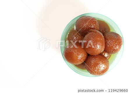 Delicious Indian dessert Gulab Jamun in blue bowl on white background. Delicious Indian dessert Gulab Jamun in blue bowl on white background. 119429660