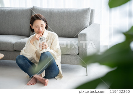 Woman operating a smartphone Woman operating a smartphone 119432260