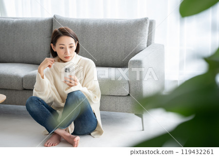 Woman operating a smartphone 119432261