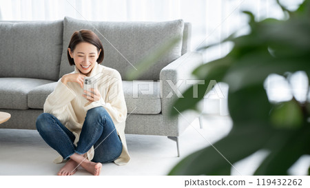 Woman operating a smartphone Woman operating a smartphone 119432262