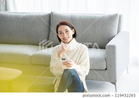 Woman operating a smartphone Woman operating a smartphone 119432265