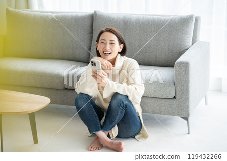 Woman operating a smartphone Woman operating a smartphone 119432266