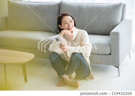 Woman operating a smartphone Woman operating a smartphone 119432269