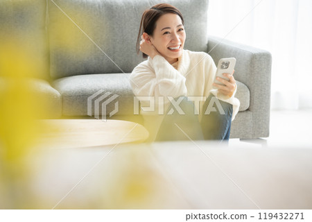 Woman operating a smartphone Woman operating a smartphone 119432271