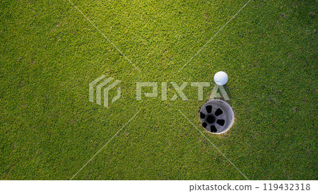 Golf ball on green grass in the evening golf course with sunshine background. Golf ball on green grass in the evening golf course with sunshine background. 119432318