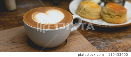 Hot coffee in white cup on wooden tray with Copy space. Banner cover design. Hot coffee in white cup on wooden tray with Copy space. Banner cover design. 119433400